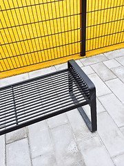 Image showing Metal bench near bright yellow playground