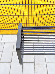 Image showing Bright yellow playground and metal bench