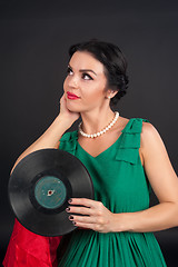 Image showing Pretty girl holding vinyl disc