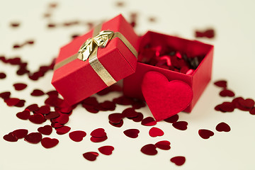 Image showing Red hearts confetti on wooden background