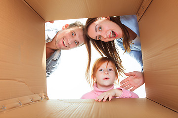 Image showing Family in a cardboard box ready for moving house