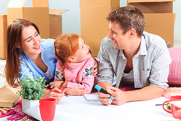 Image showing The happy family  during repair and relocation