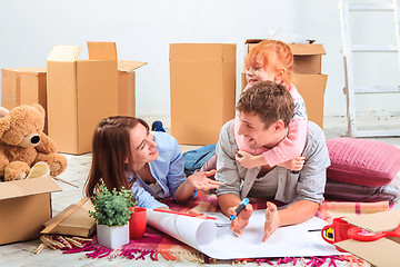 Image showing The happy family  during repair and relocation