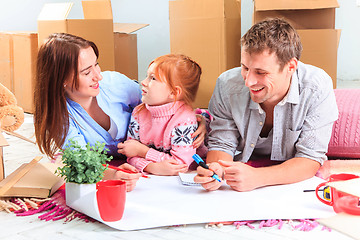 Image showing The happy family  during repair and relocation