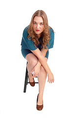 Image showing Woman sitting on chair bend forwards.