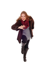 Image showing Dancing woman in winter coat.