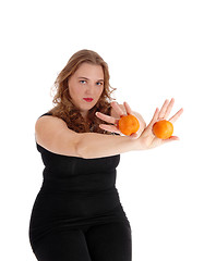 Image showing Woman holding two oranges.