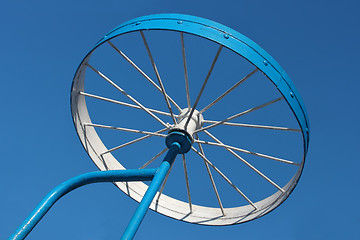 Image showing Metal detail as a bicycle wheel against the sky