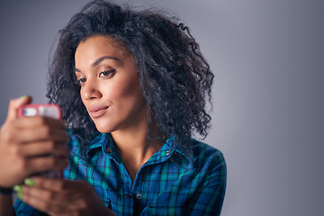 Image showing Woman taking self portrait with smart phone