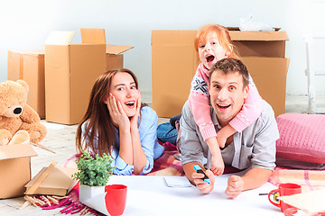 Image showing The happy family  during repair and relocation