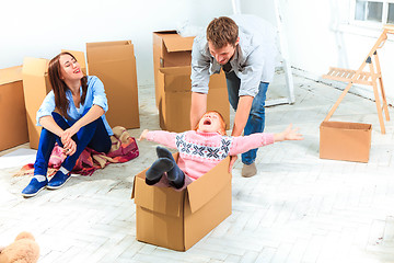 Image showing The happy family  during repair and relocation