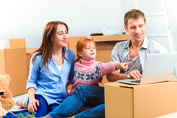 Image showing The happy family  during repair and relocation