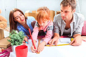 Image showing The happy family  during repair and relocation