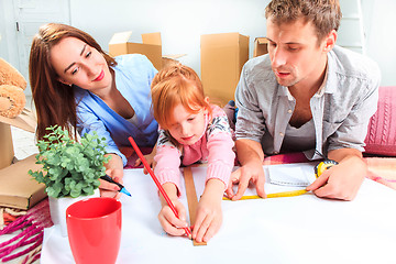 Image showing The happy family  during repair and relocation