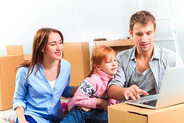 Image showing The happy family  during repair and relocation