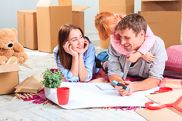 Image showing The happy family  during repair and relocation