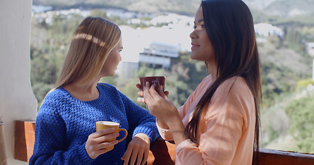 Image showing Young women chatting on an open-air patio