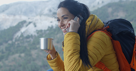 Image showing Happy female hiker on phone