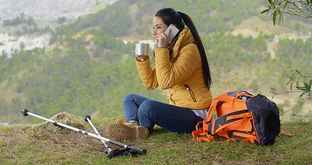 Image showing Happy backpacker on phone and waving hand