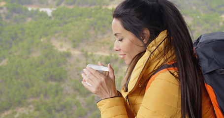 Image showing Young woman backpacker savoring her coffee