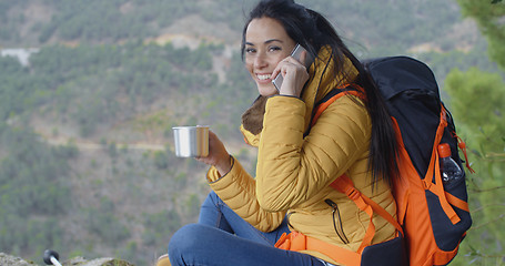 Image showing Happy female hiker on phone
