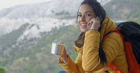 Image showing Hiker talking on phone during a break