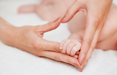 Image showing Baby holding mother finger and together form heart shape by hand.