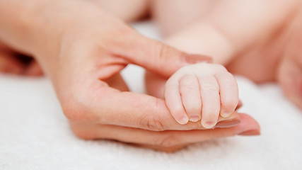 Image showing sleeping baby in hand of parent 