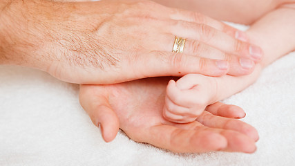 Image showing sleeping baby in hand of parent 