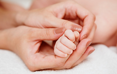 Image showing Baby holding mother finger 