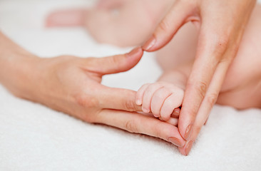 Image showing Baby holding mother finger and together form heart shape by hand.