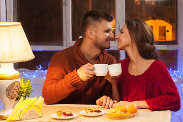 Image showing The  happy young couple with cups of tea 
