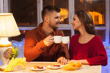 Image showing The  happy young couple with cups of tea 