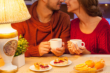 Image showing The  happy young couple with cups of tea 
