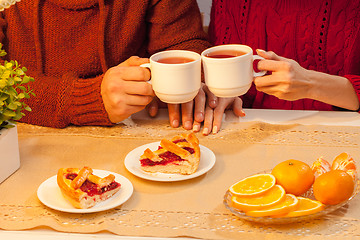 Image showing The  happy young couple with cups of tea 