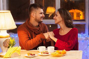 Image showing The  happy young couple with cups of tea 