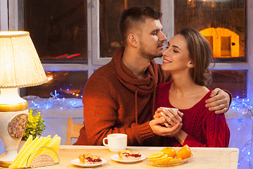 Image showing The  happy young couple with cups of tea 