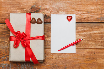 Image showing Vintage gift box with small hearts  on  wooden background