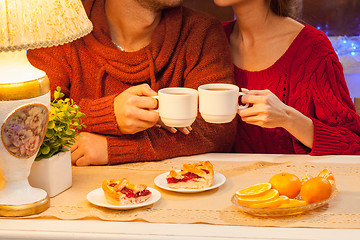 Image showing The  happy young couple with cups of tea 