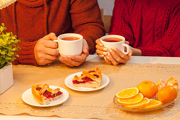 Image showing The  happy young couple with cups of tea 