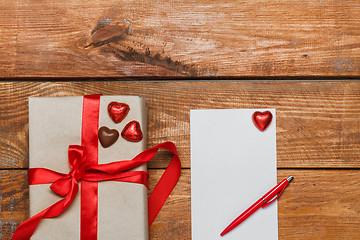 Image showing Vintage gift box with small hearts  on  wooden background