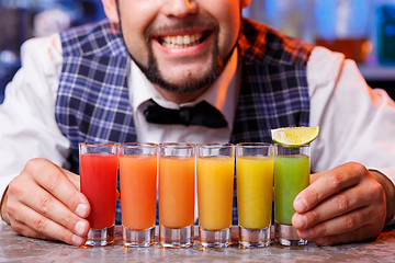 Image showing Barman at work, preparing cocktails.