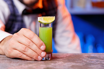 Image showing Barman at work, preparing cocktails.