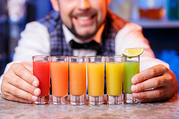 Image showing Barman at work, preparing cocktails.