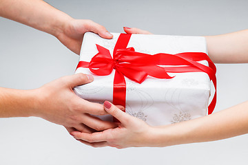 Image showing Hands giving and receiving a present