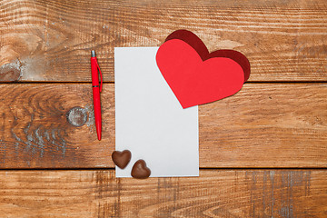 Image showing The blank sheet of paper and pen with small hearts  
