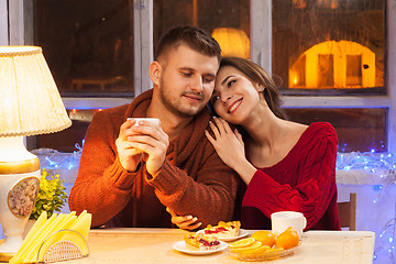 Image showing The  happy young couple with cups of tea 