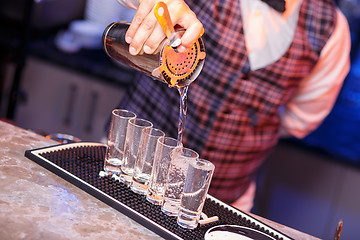 Image showing Barman at work, preparing cocktails.