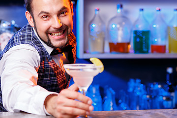 Image showing Barman at work, preparing cocktails.