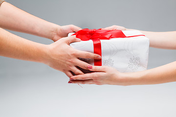 Image showing Hands giving and receiving a present